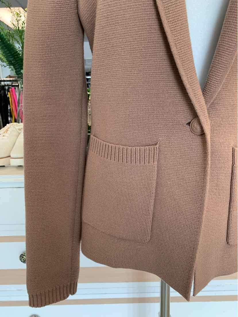 Tan knitted blazer with patch pockets and notch lapel collar on a mannequin.