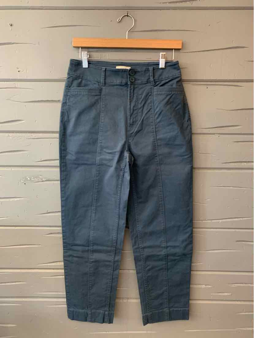 Dark blue Loft straight-leg pants with a button closure, belt loops, and front pockets, hanging on a wooden hanger.