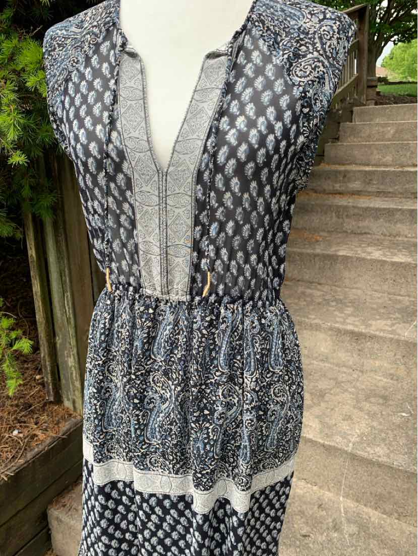 Sleeveless paisley dress with deep V-neck and gathered waist in navy and white colors.