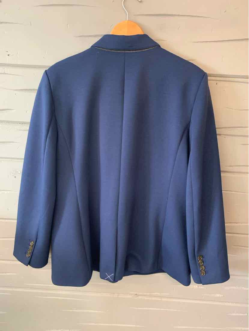 Navy blue tailored blazer with structured shoulders and buttoned cuffs hanging on wooden hanger.
