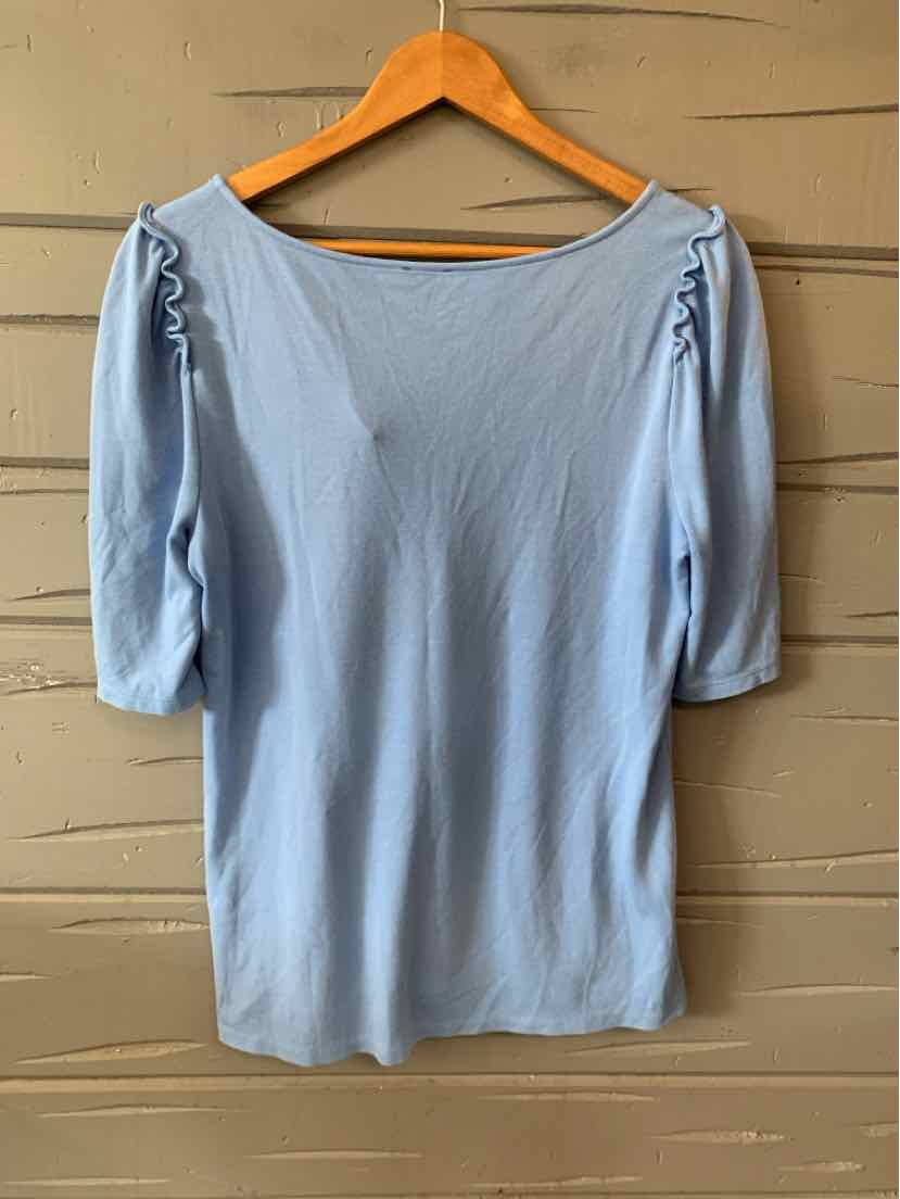 Light blue blouse with three-quarter sleeves and ruched detailing at shoulder seams, soft fabric.