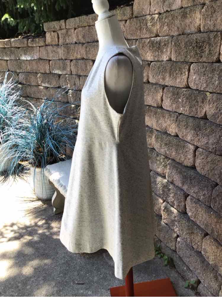 Light gray sleeveless A-line dress with a scoop neckline and soft, draped fabric.