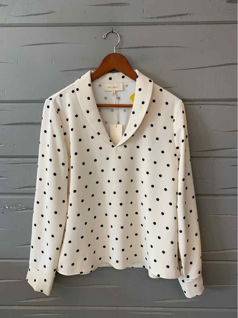 White long-sleeve blouse with black polka dots and a wide collar on wooden hanger.