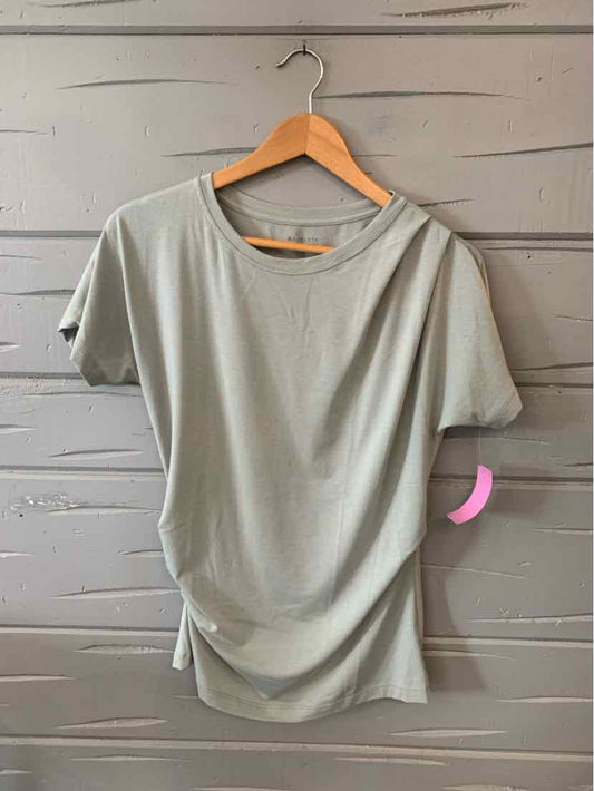 Light sage green short-sleeve top with relaxed fit and gathered side detail, size XS.