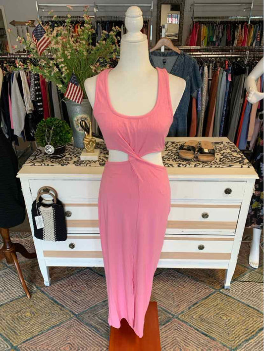 Pink sleeveless maxi dress with scoop neckline and waist cutout on mannequin.