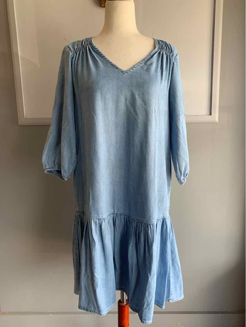 Light blue knee-length dress with V-neck, gathered shoulders, 3/4 puff sleeves, and tiered ruffle hem.