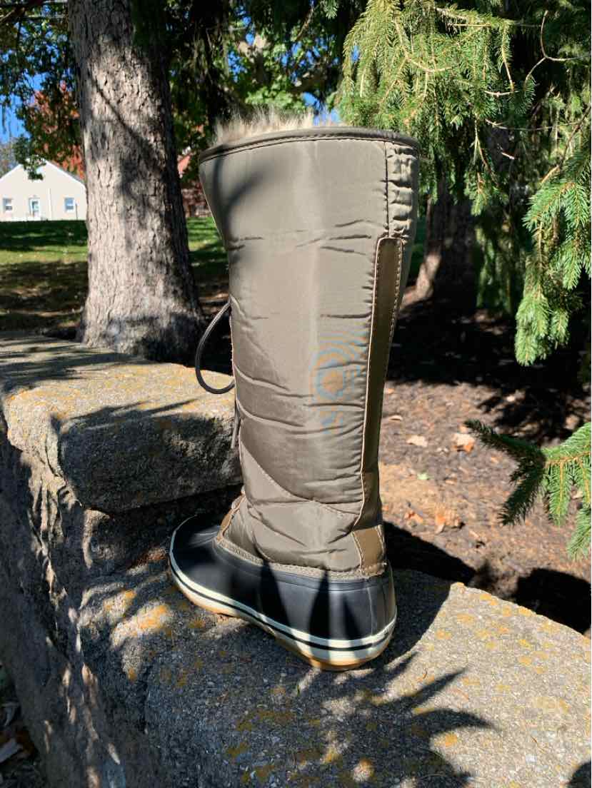 Tall taupe-gray leather boot with stitched panels, side zipper, and chunky black lug sole.