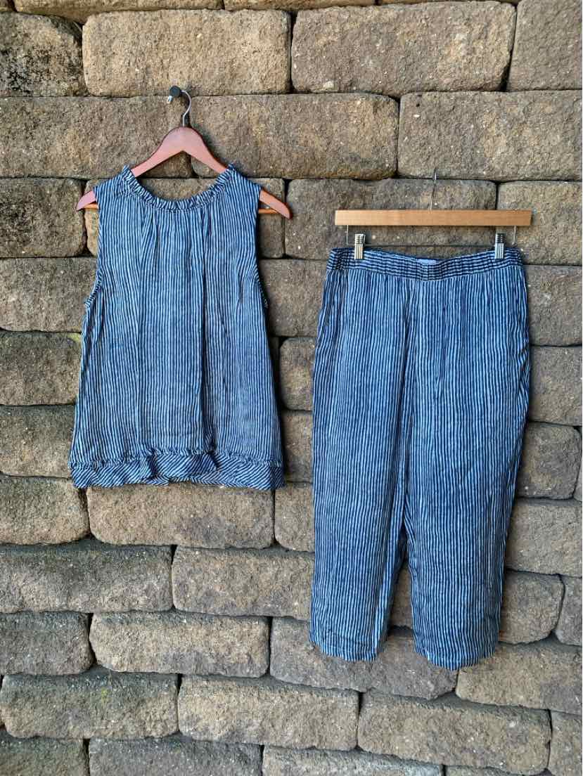 Light blue sleeveless blouse with gathered neckline and matching cropped pants with elastic waistband.