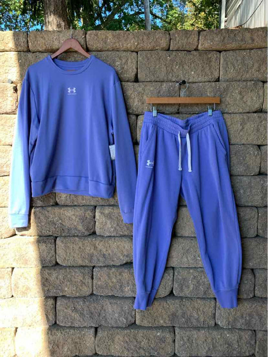 Blue Under Armour sweatshirt and matching drawstring joggers with white sleeve and side accents.