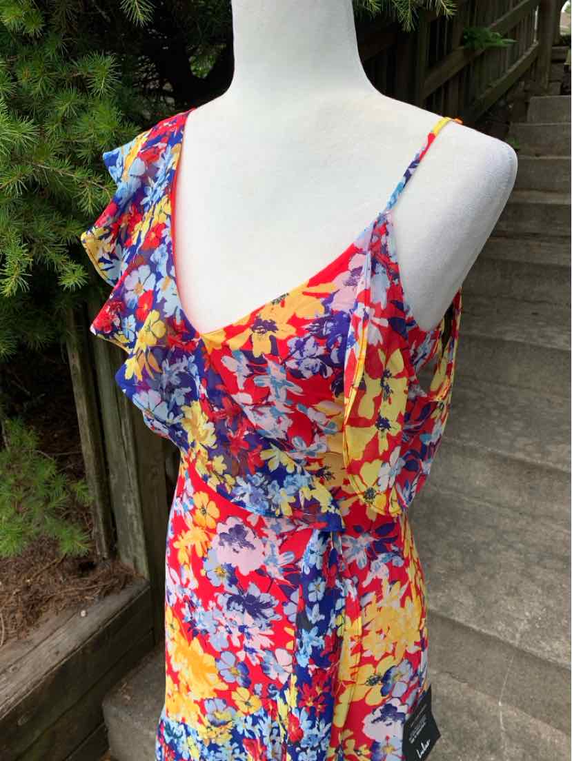 Sleeveless floral dress with yellow, red, blue, and purple flowers, ruffled V-neckline, and thin shoulder straps.