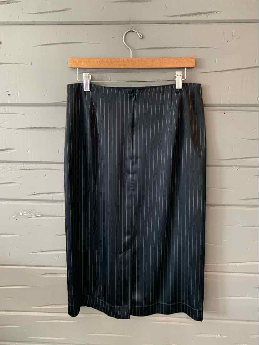 Black midi skirt with vertical pinstripes and front button closure hanging on wooden hanger.