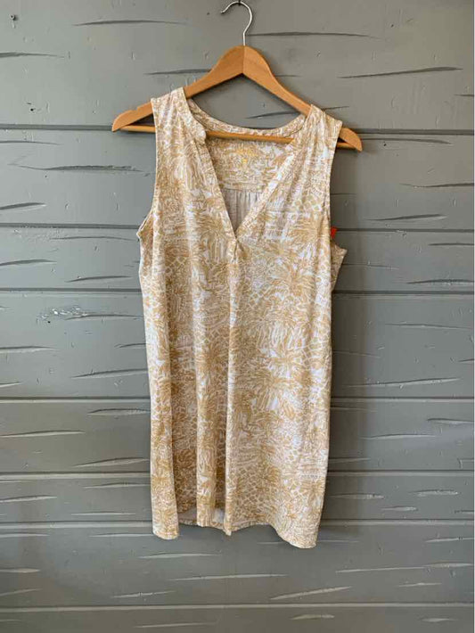Sleeveless tan dress with white abstract floral print, V-neckline, knee-length, lightweight fabric.
