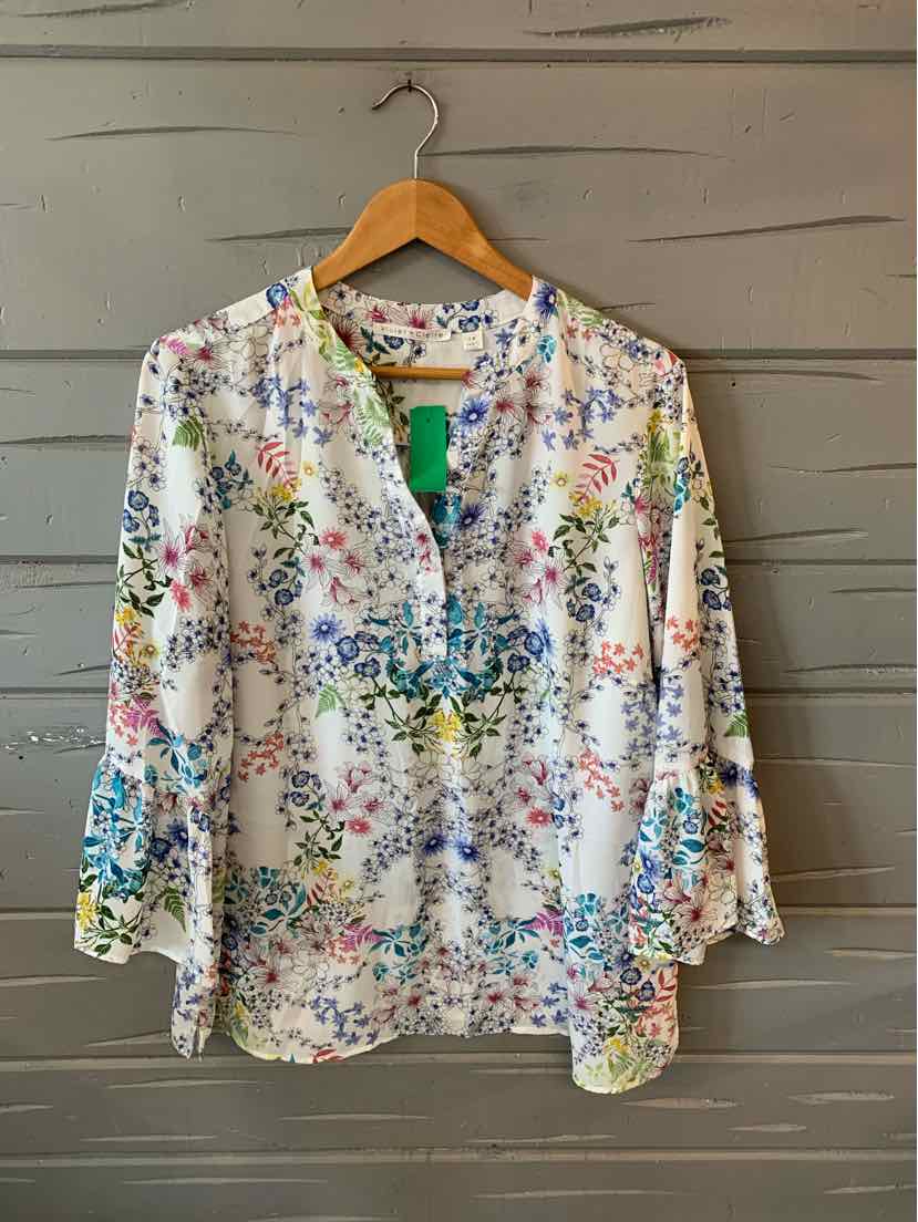 White blouse with colorful floral print, V-neck, three-quarter sleeves, and relaxed fit in size 1X.
