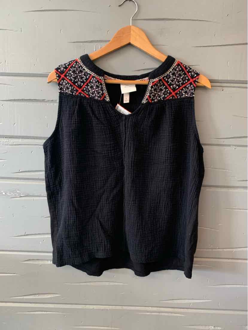 Black sleeveless top with embroidered red and white geometric patterns on shoulders and neckline.