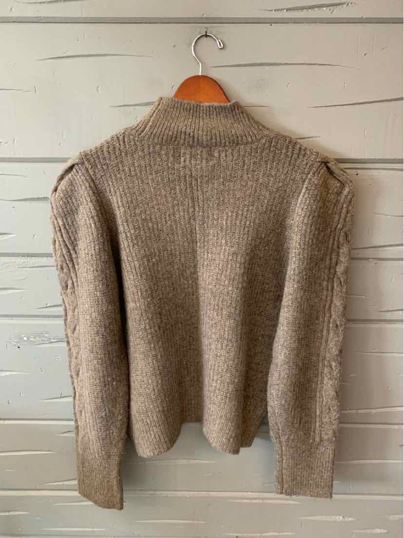 Brown ribbed knit sweater with long sleeves, a high neckline, and a cropped hem.