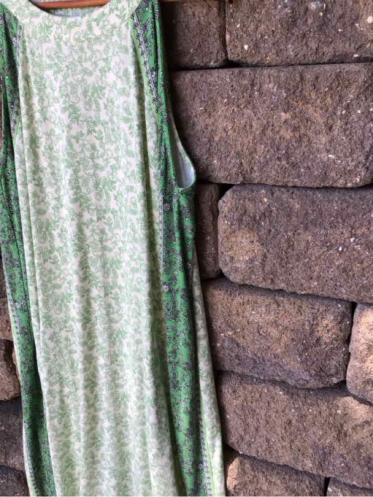 Sleeveless green floral maxi dress with a relaxed fit and round neckline.