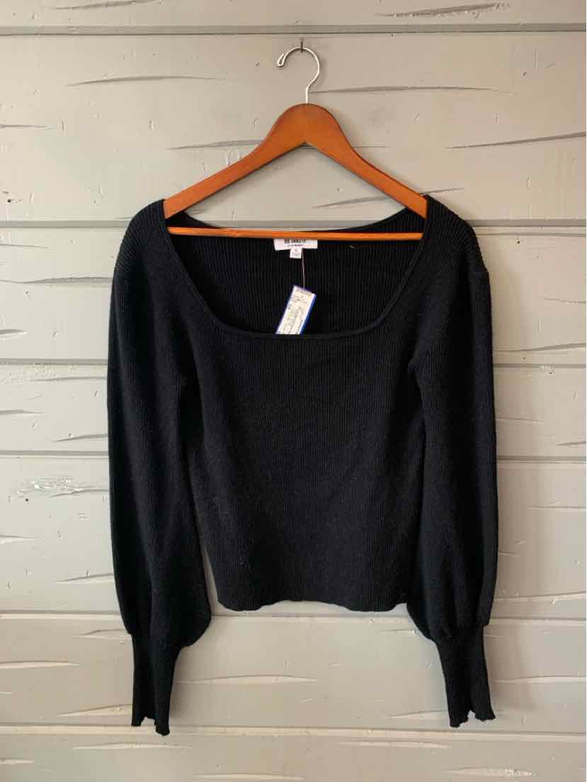 Black women’s long-sleeve knit top with a wide square neckline and fitted cuffs, displayed on a hanger.