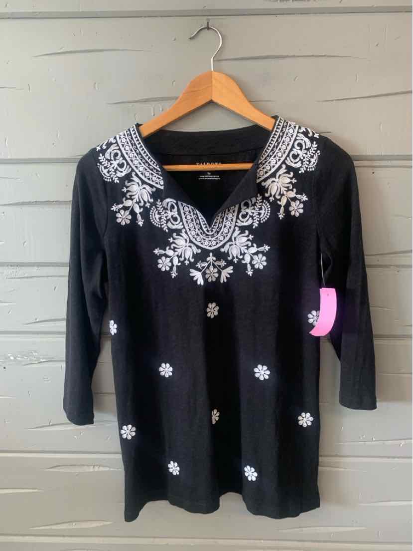 Black long-sleeve top with white floral embroidery around neckline and scattered on front, V-neck with small keyhole cutout.
