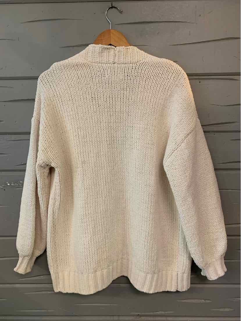 Cream-colored knit sweater with long sleeves and ribbed cuffs and hem in size XS.