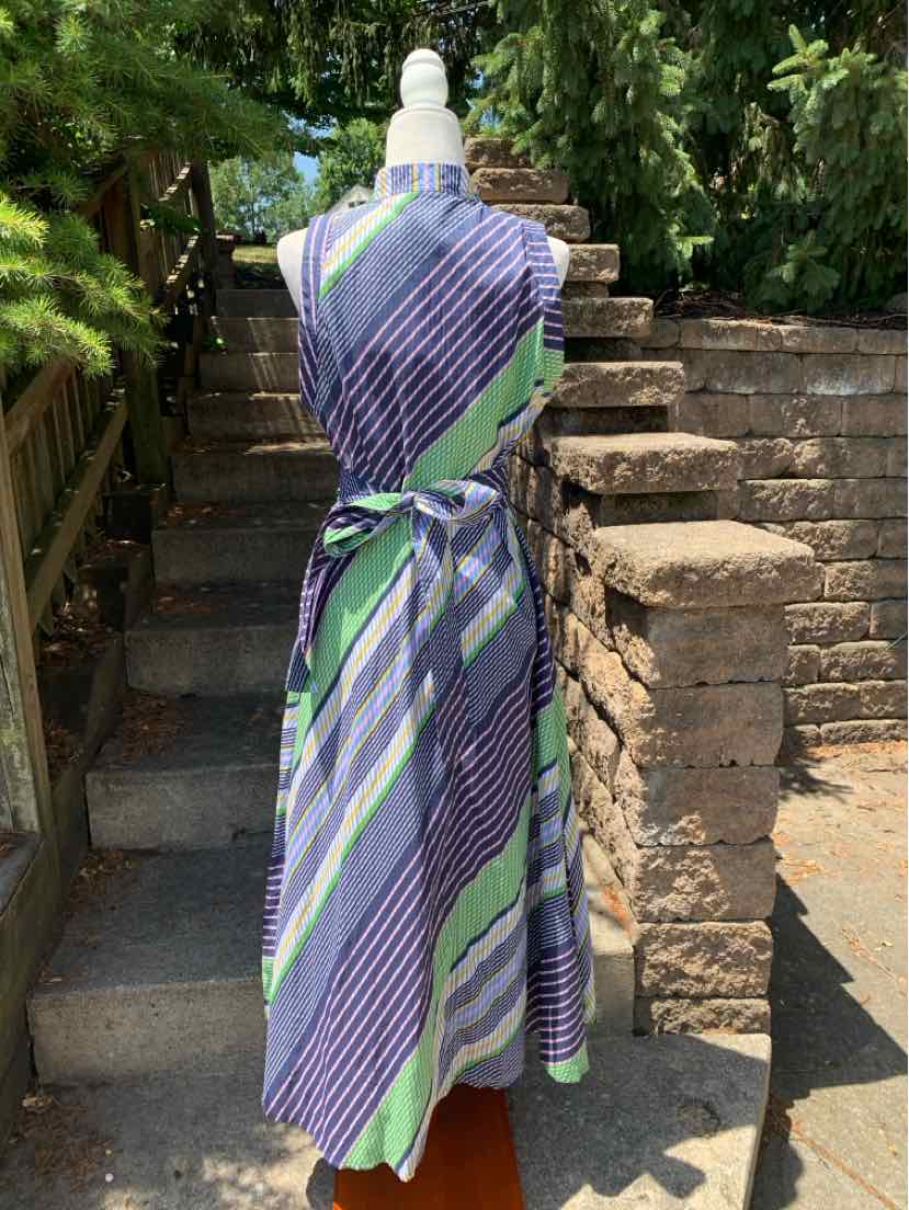 Sleeveless wrap dress with diagonal blue, green, and white stripes, tied at the waist.