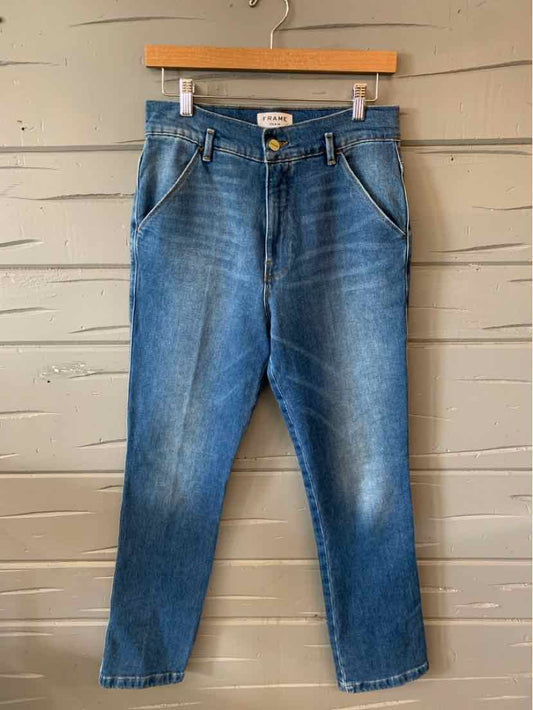Blue denim jeans with a tapered fit, classic five-pocket design, and subtle whiskering around the hips.
