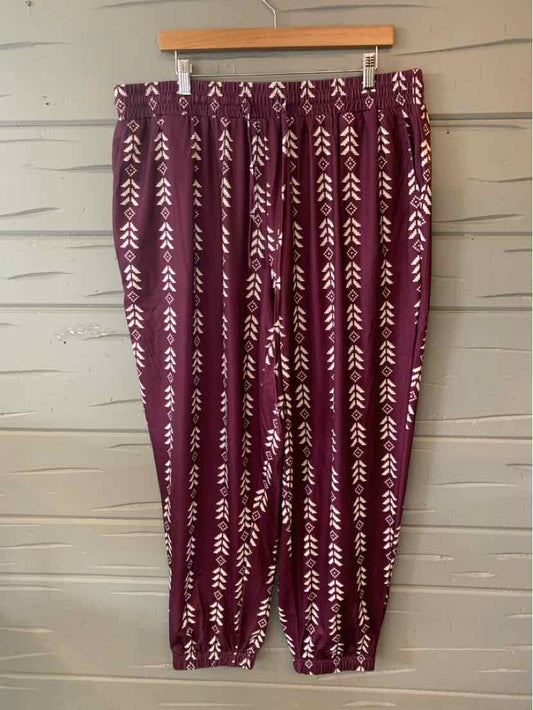 Burgundy pants with vertical white arrow patterns, elastic waistband, loose fit, lightweight fabric.