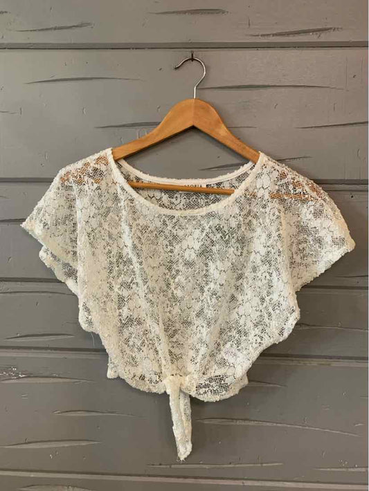 White lace short-sleeve crop top with front tie detail on wooden hanger.