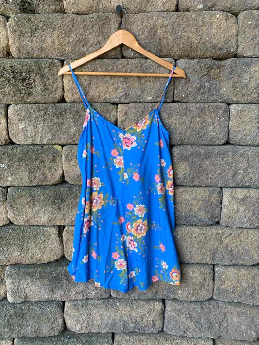 Blue floral slip dress with spaghetti straps and a loose, flowy fit.