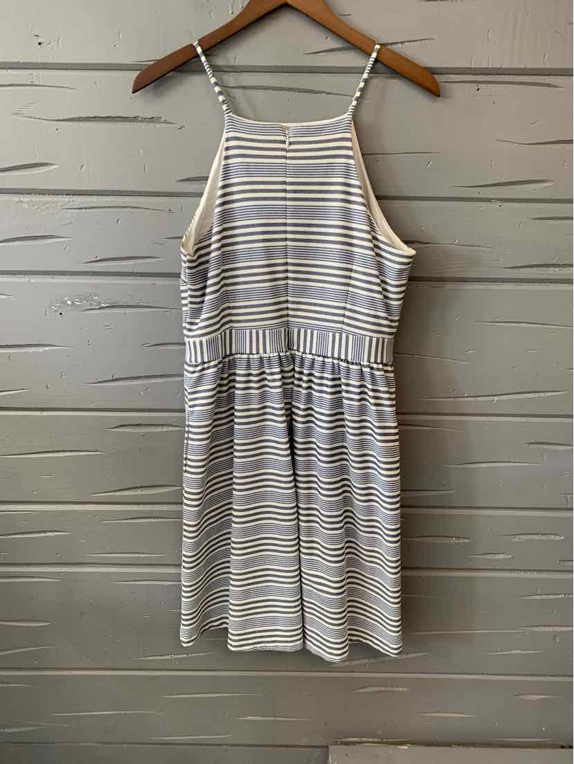 Sleeveless white dress with thin navy and beige horizontal stripes and adjustable spaghetti straps.