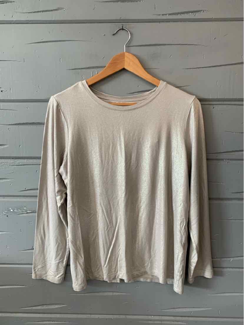Light beige long-sleeve crew neck shirt with loose fit on wooden hanger against gray wall.
