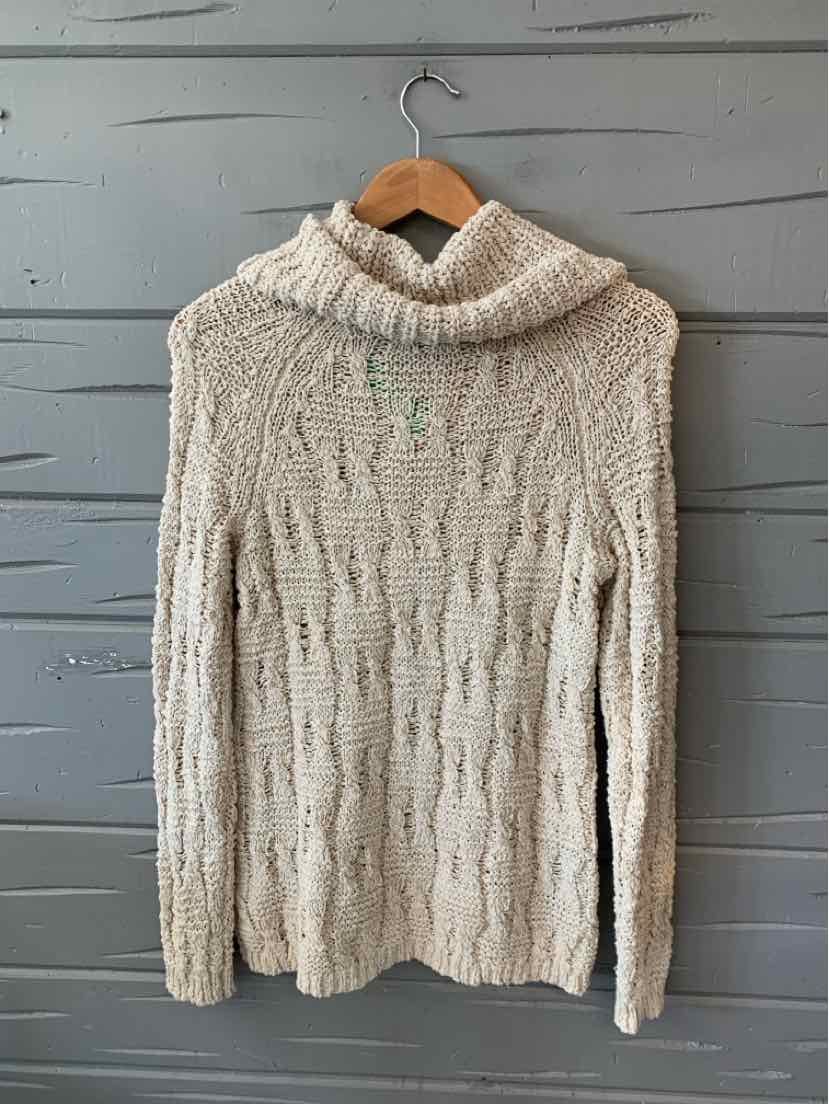 Cream-colored knit sweater with a chunky cable pattern and a thick turtleneck collar.