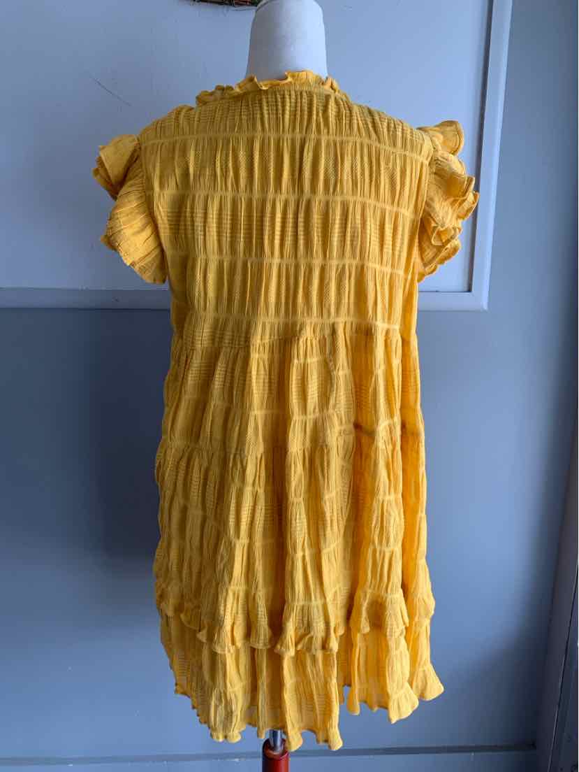 Yellow short-sleeve dress with ruffled edges and textured vertical stripes in medium size.