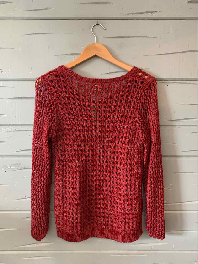 Burgundy open-knit long-sleeve sweater with crew neckline hanging on wooden hanger.
