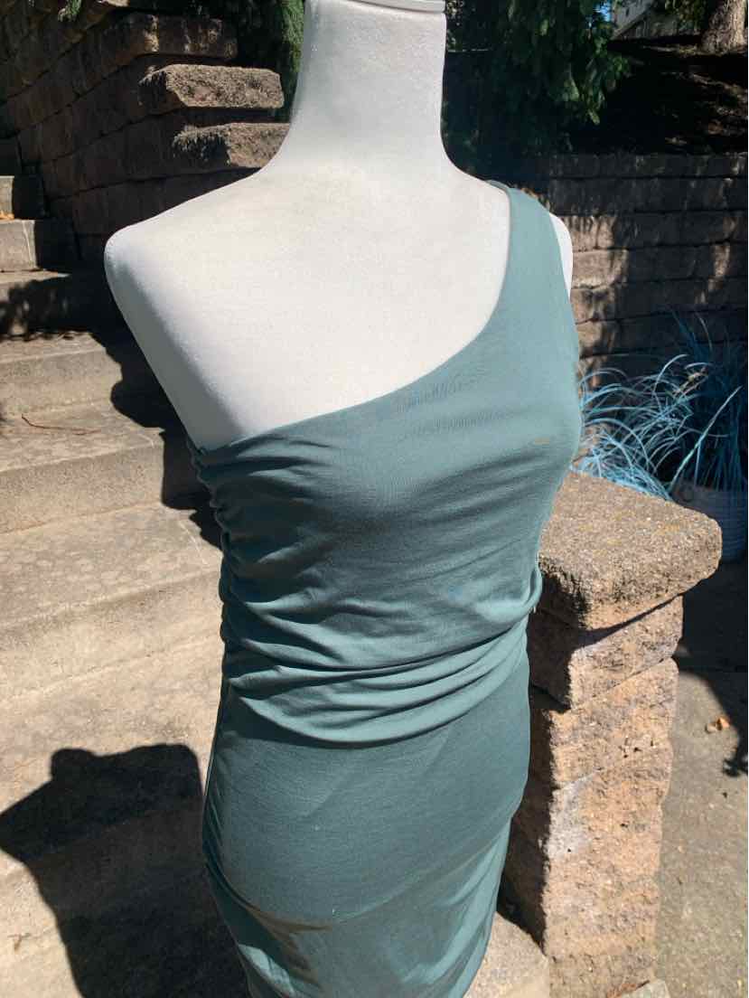 One-shoulder fitted dress in muted green stretch fabric with ruched detailing at the waist.