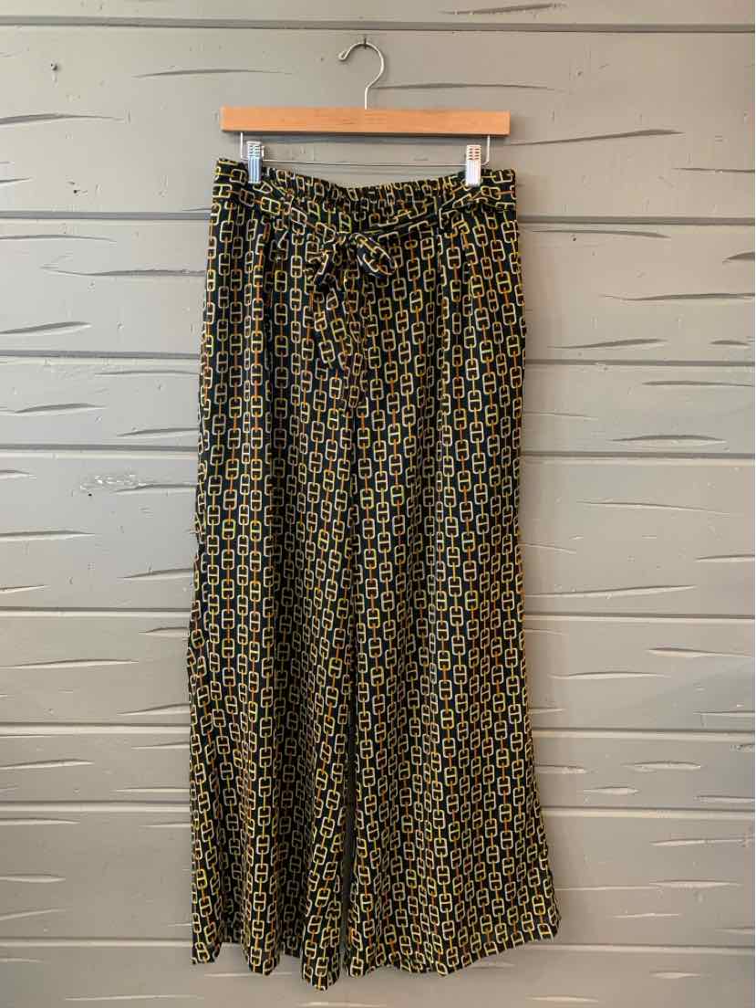 High-waist wide-leg pants with black and mustard geometric pattern and a matching fabric belt.