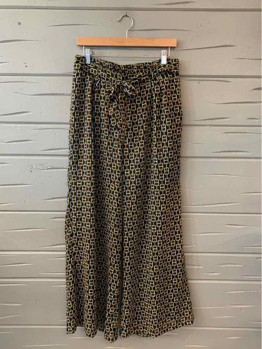 High-waist wide-leg pants with black and mustard geometric pattern and a matching fabric belt.