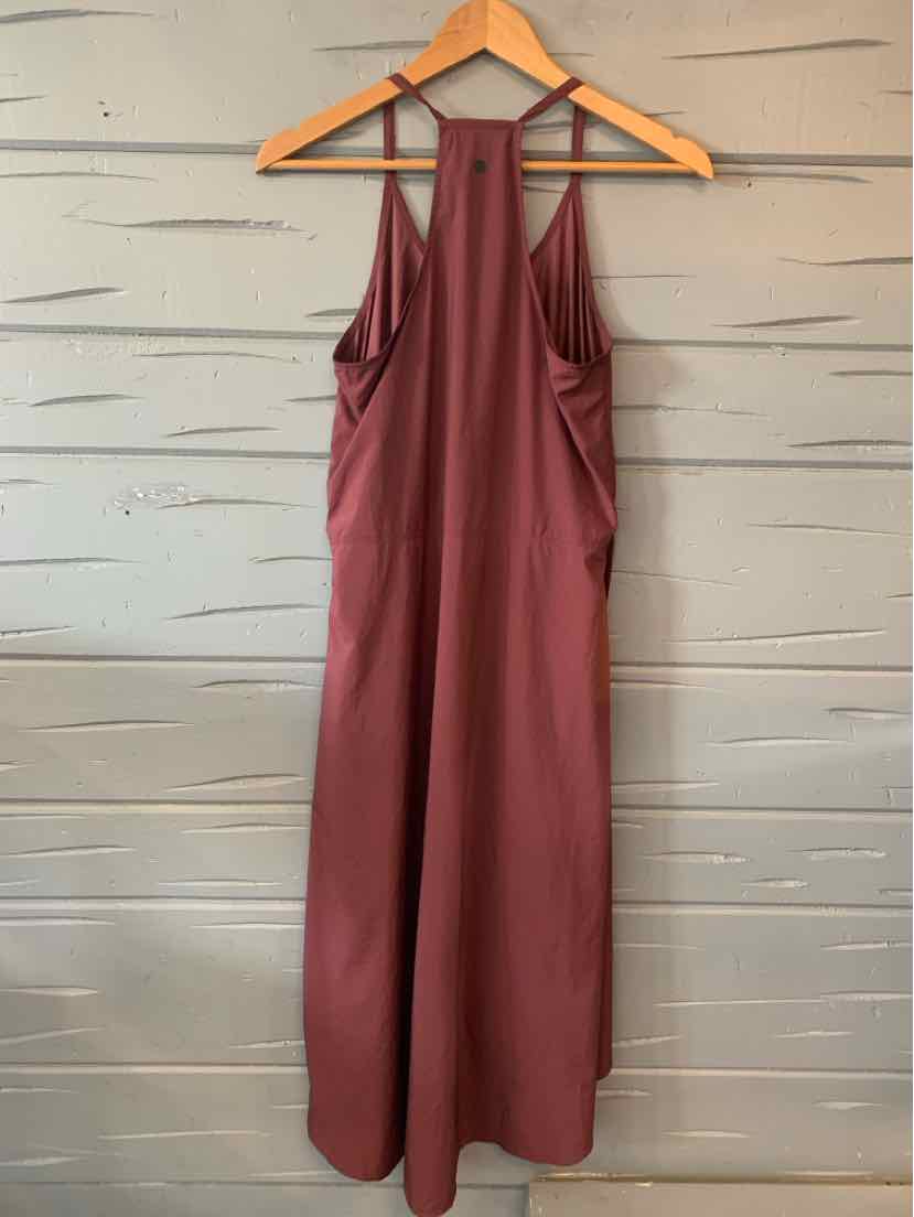 Burgundy sleeveless jumpsuit with wide legs, high neckline, and racerback straps on wooden hanger.