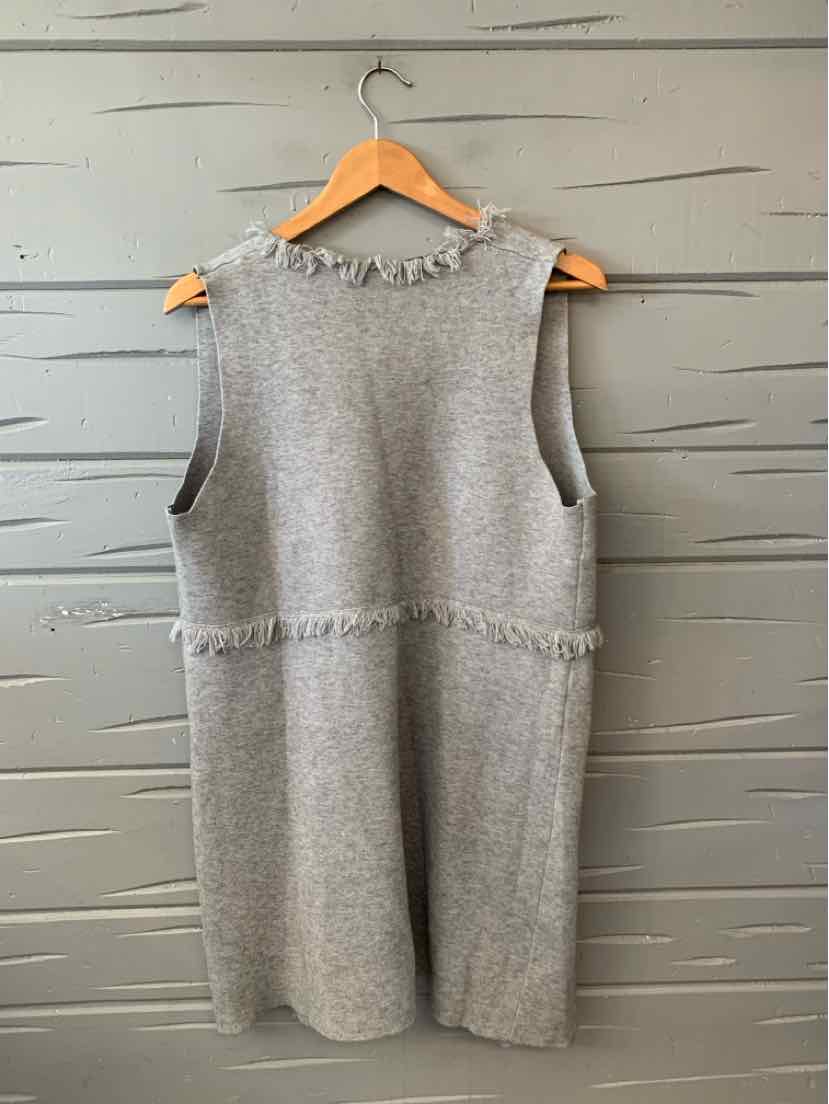 Gray sleeveless knit sweater vest with a round neckline, textured waist band, and long tunic-length hem.