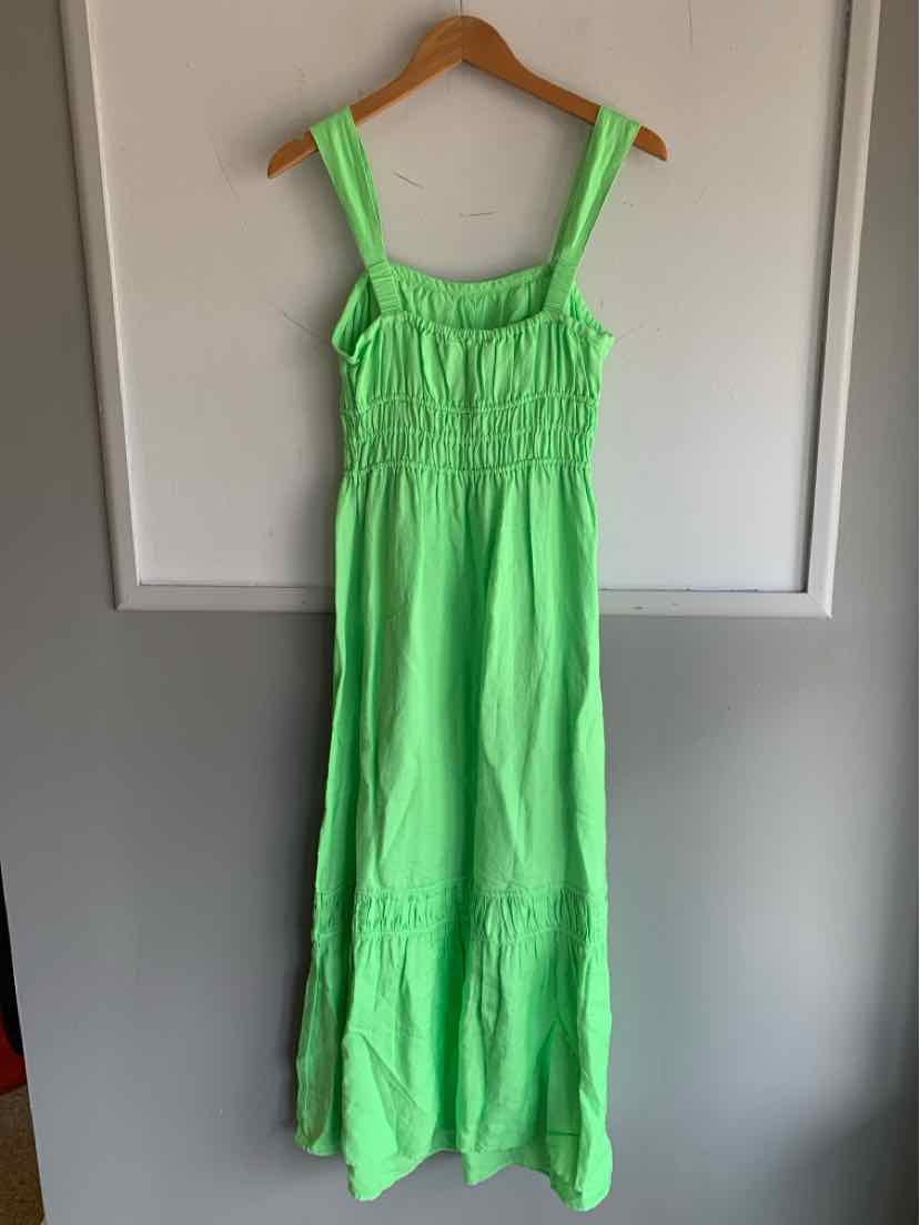 Light green sleeveless maxi dress with gathered bodice and square neckline on wooden hanger.