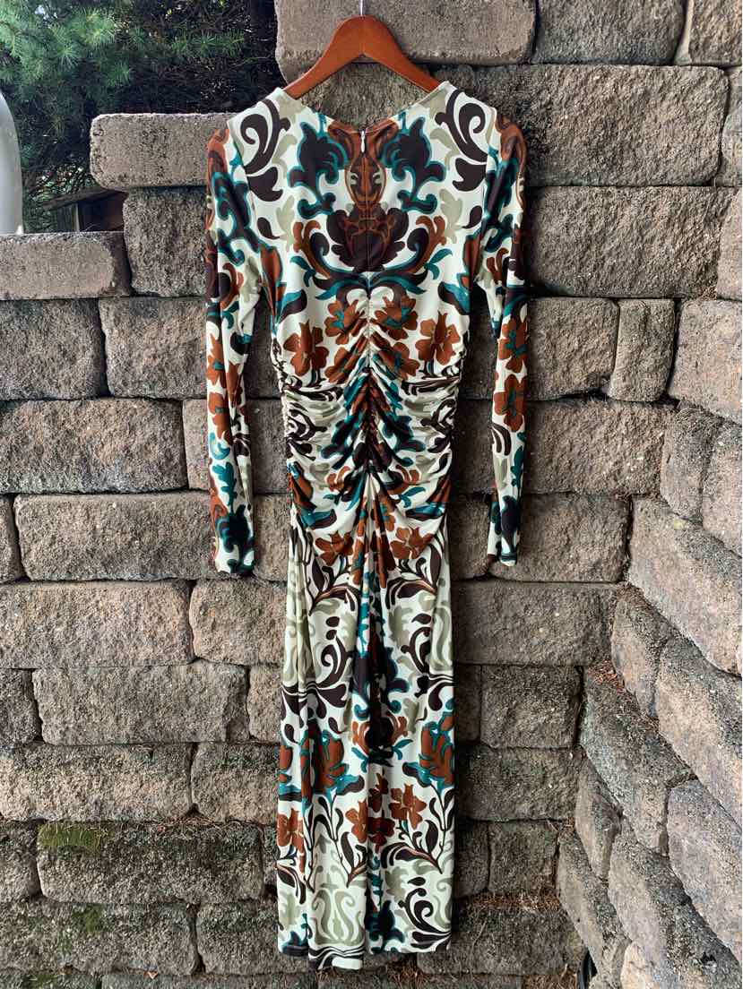 Long-sleeve fitted dress with ruched front in multicolor floral pattern featuring teal, brown, and cream tones.