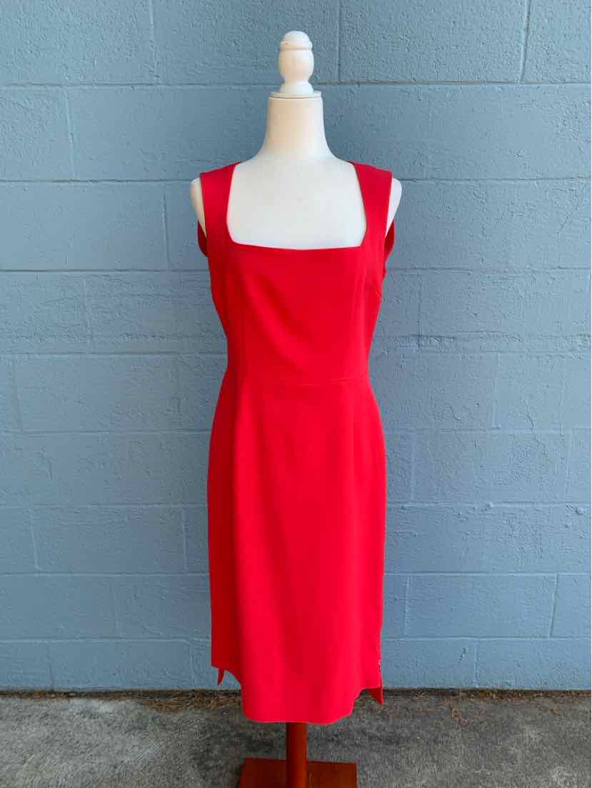 Red sleeveless knee-length dress with square neckline on mannequin.
