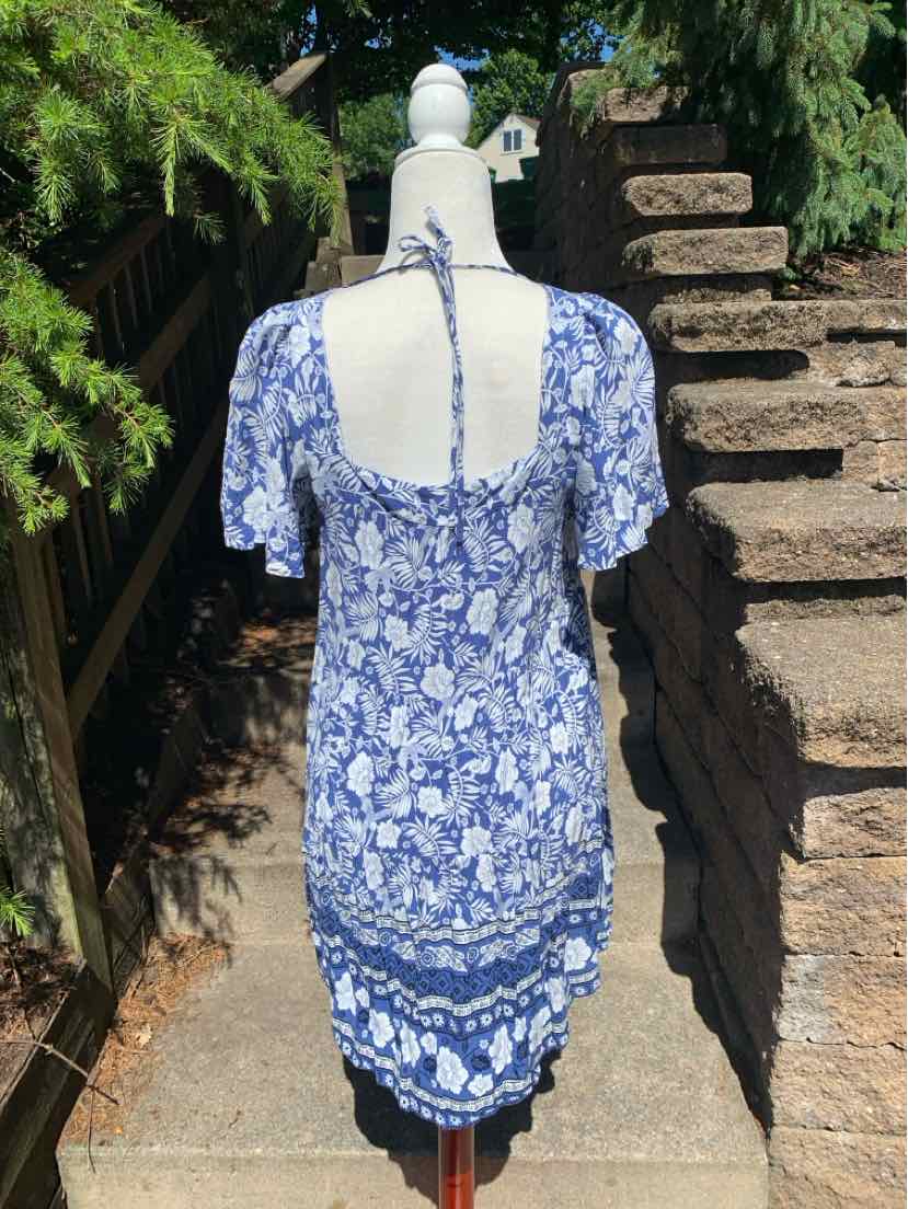 Blue and white floral midi dress with puff sleeves and square neckline back detail.