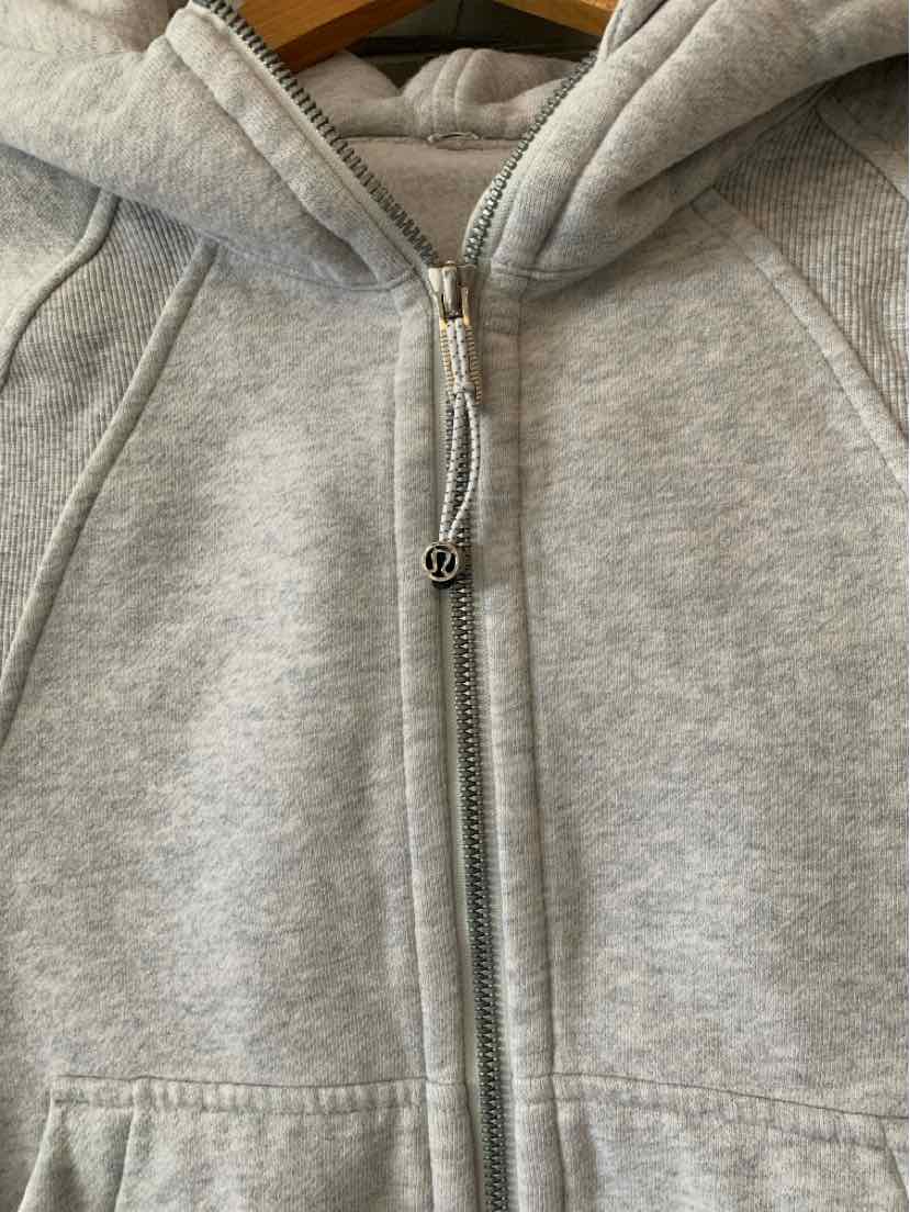 Light gray zip-up hoodie with silver zipper and side pockets, soft fabric, size XS/S.