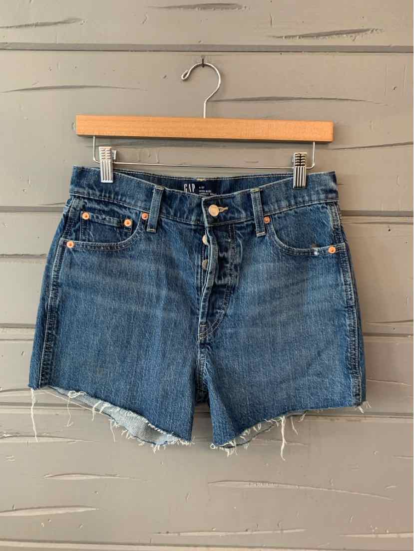 Blue denim high-waist shorts with front button fly and frayed hem, size 4.
