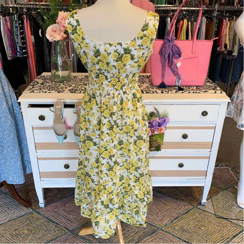 Yellow and white floral sleeveless midi dress with square neckline and fitted waist.