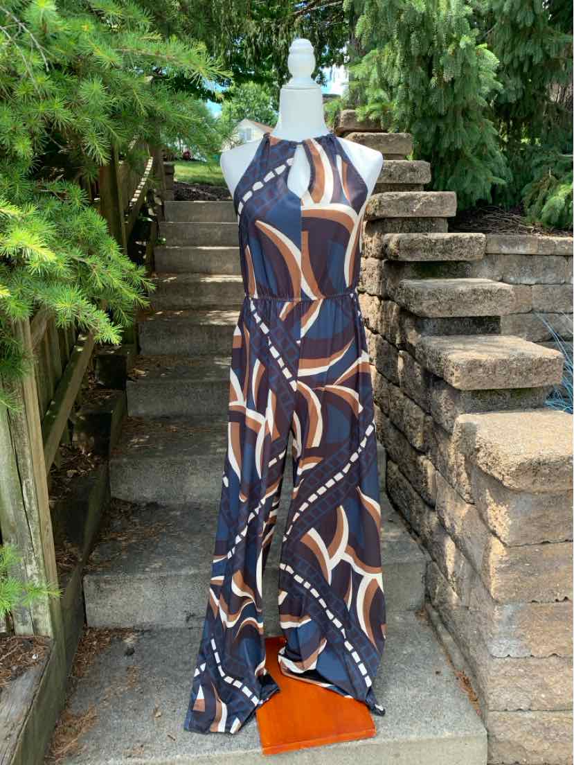 Sleeveless maxi dress with geometric brown, navy blue, and white print and halter neckline.