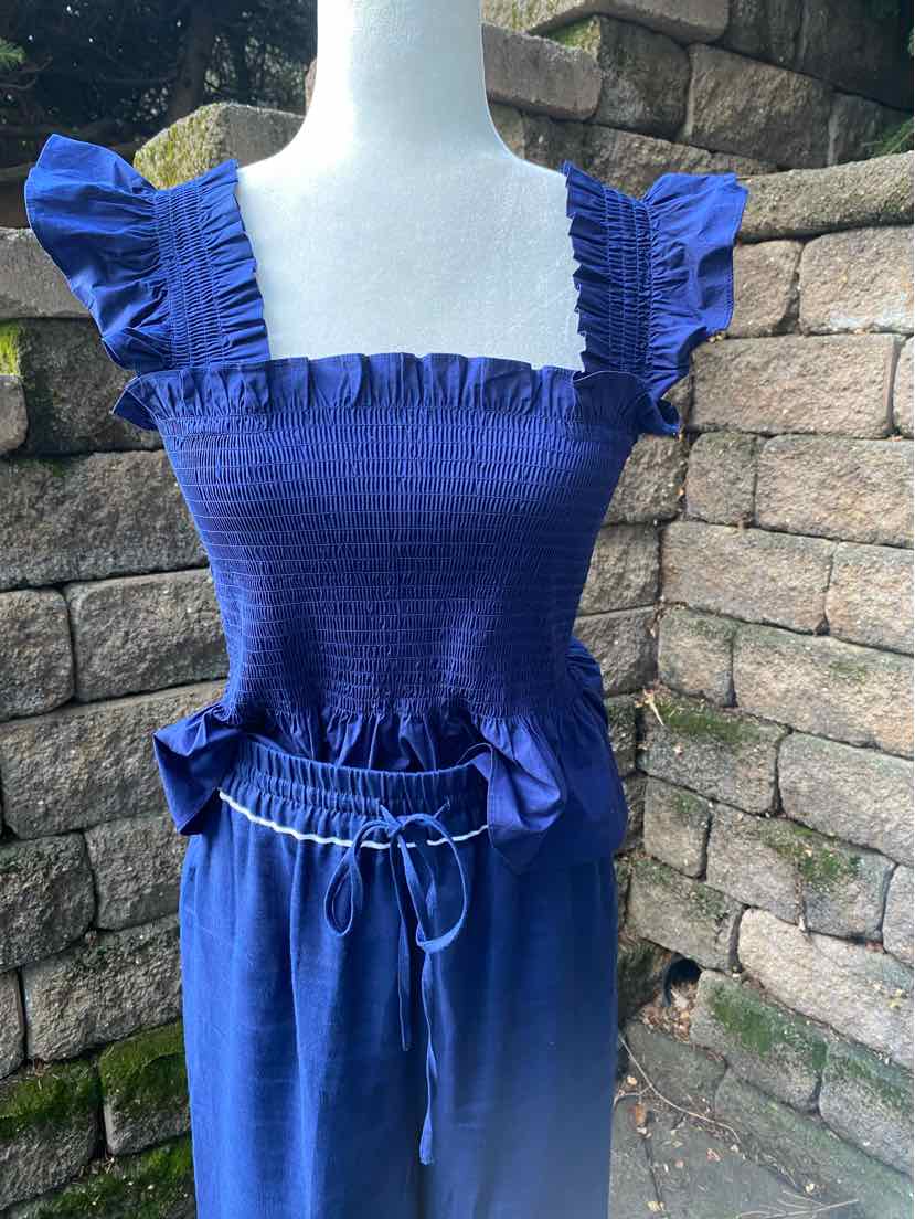 Blue smocked square-neck top with ruffled straps paired with matching high-waisted drawstring pants.