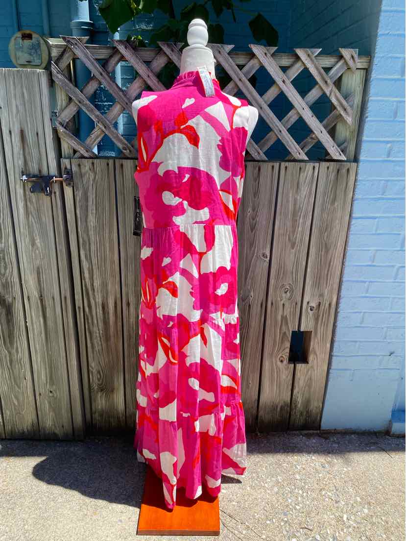 Pink and white floral sleeveless maxi dress with a flowing, tiered skirt and high neckline.