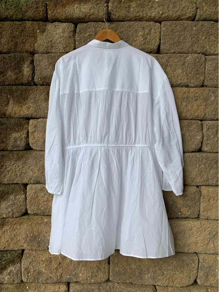 White long-sleeve lightweight coat with gathered waist and flowy hem hanging on wooden hanger.