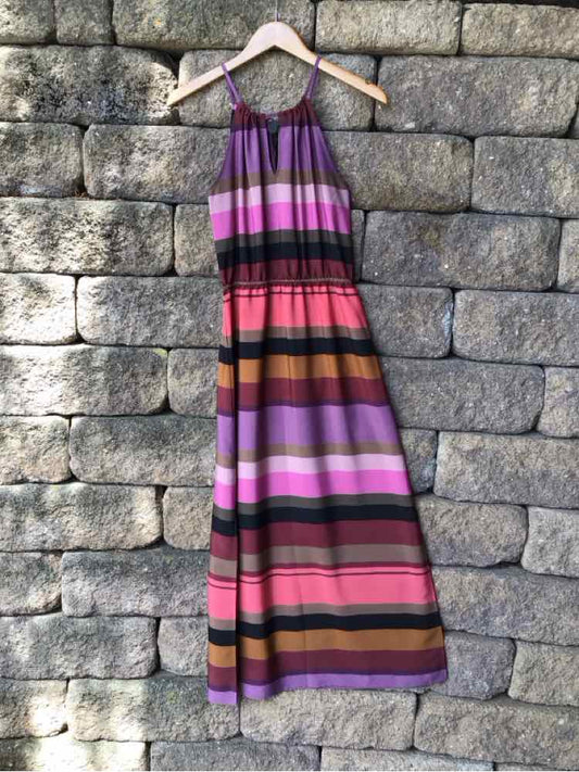 Sleeveless color block maxi dress with purple, pink, red, and brown horizontal stripes, gathered waist, and adjustable.